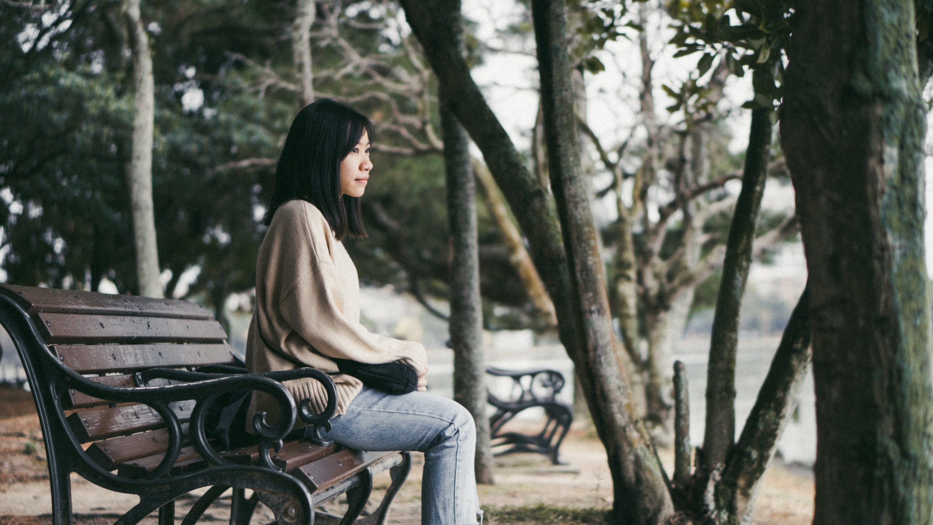 Photo of a woman sitting on a park bench